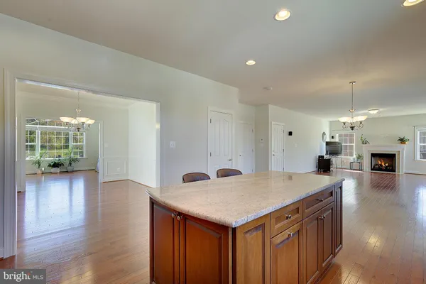 a view of a livingroom with fireplace wooden floor and windows