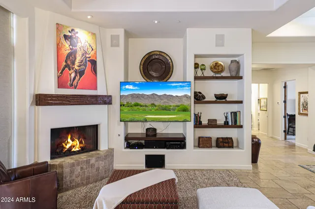 a very nice looking open dining room with furniture a kitchen and chandelier