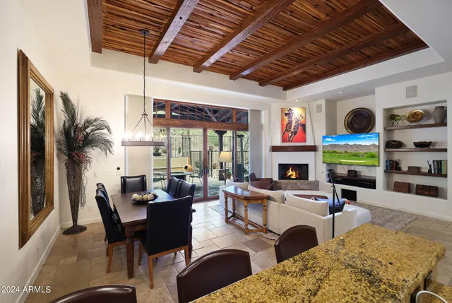 a living room with furniture fireplace and flat screen tv