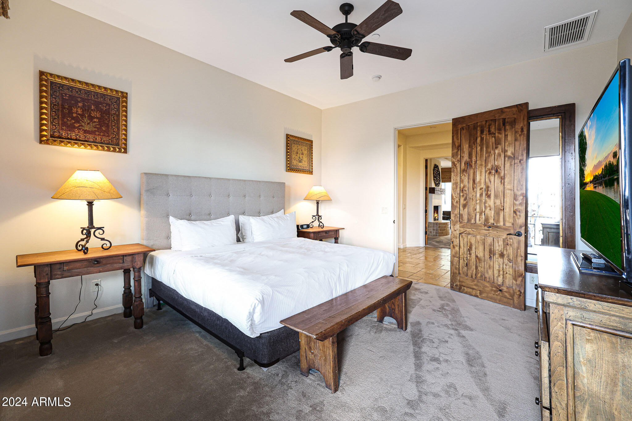 27440 North Alma School Parkway, Unit 363 Scottsdale, AZ 85262 - Photo 23 of 53 a spacious bedroom with a bed and a flat screen tv