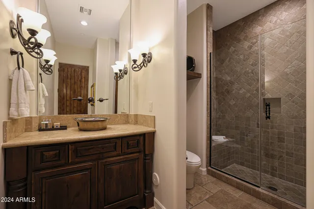 a bathroom with a toilet a sink and shower