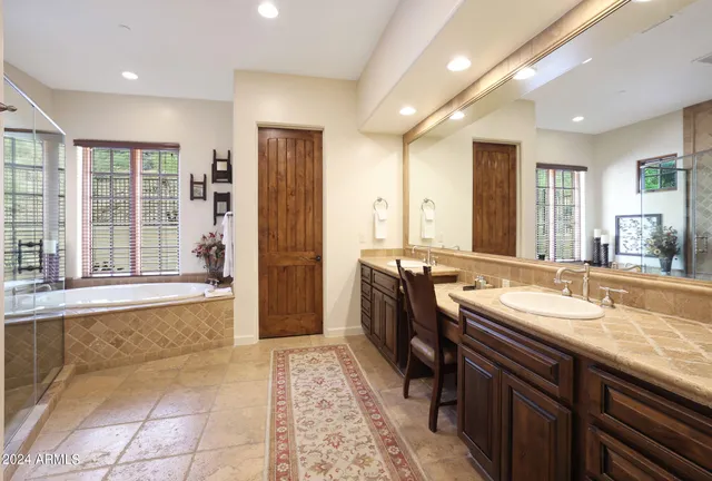 a spacious bathroom with a bathtub and next to a window