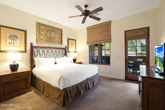 a bedroom with a bed and a flat screen tv