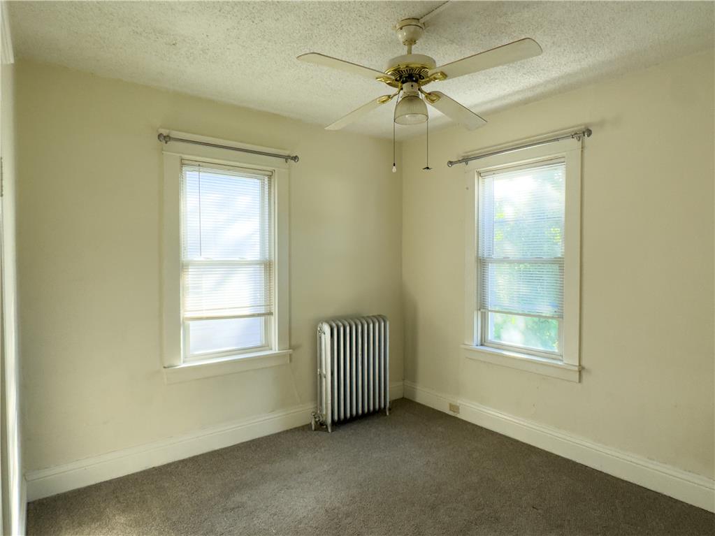 870 Chestnut Street Coplay, PA 18037 - Photo 11 of 24 A cozy bedroom with two windows providing natural light, complemented by a ceiling fan for comfort.
