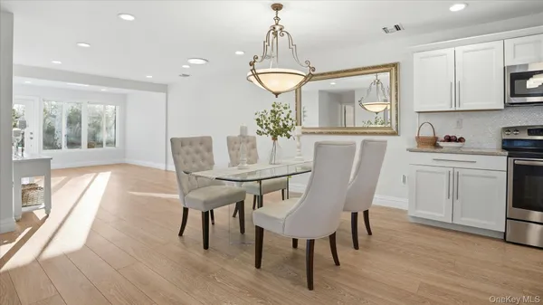 a view of a dining room with furniture window and wooden floor