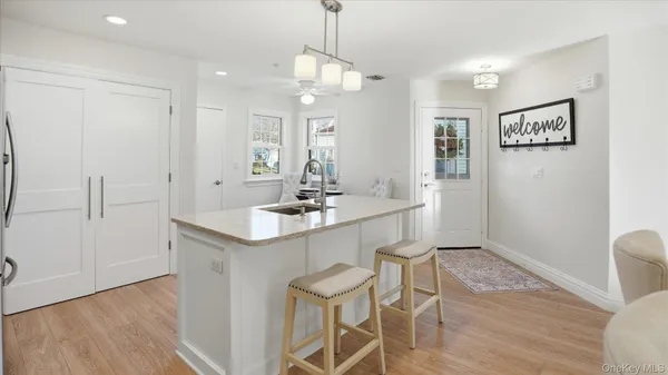 a kitchen with a sink cabinets and wooden floor