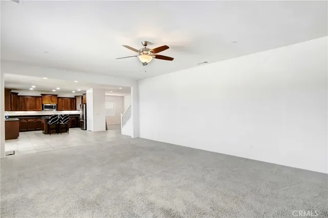 a view of a livingroom with furniture and a ceiling fan