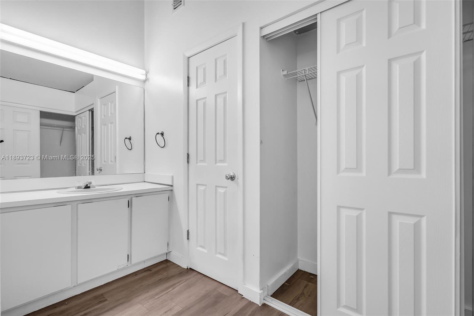 6713 Northwest 188th Terrace, Unit 6713 Hialeah, FL 33015 - Photo 15 of 28 a spacious bathroom with a double vanity sink and a mirror