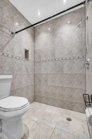 a bathroom with a toilet and a shower