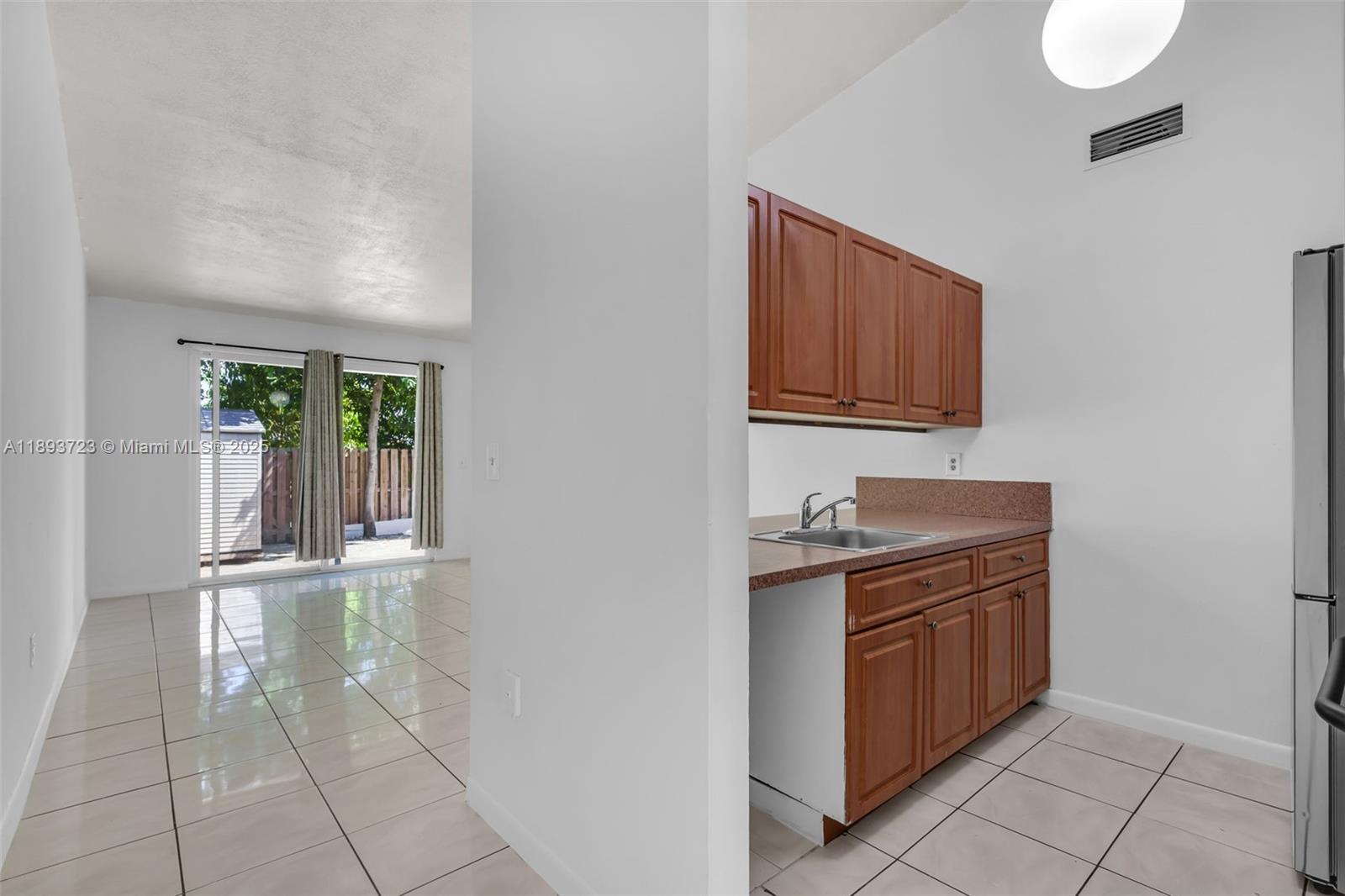 6713 Northwest 188th Terrace, Unit 6713 Hialeah, FL 33015 - Photo 2 of 28 a view of cabinets and wooden floor