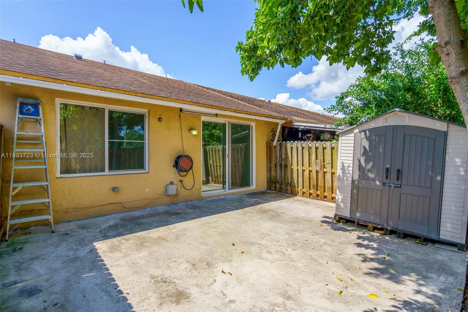 6713 Northwest 188th Terrace, Unit 6713 Hialeah, FL 33015 - Photo 22 of 28 a front view of a house with a yard