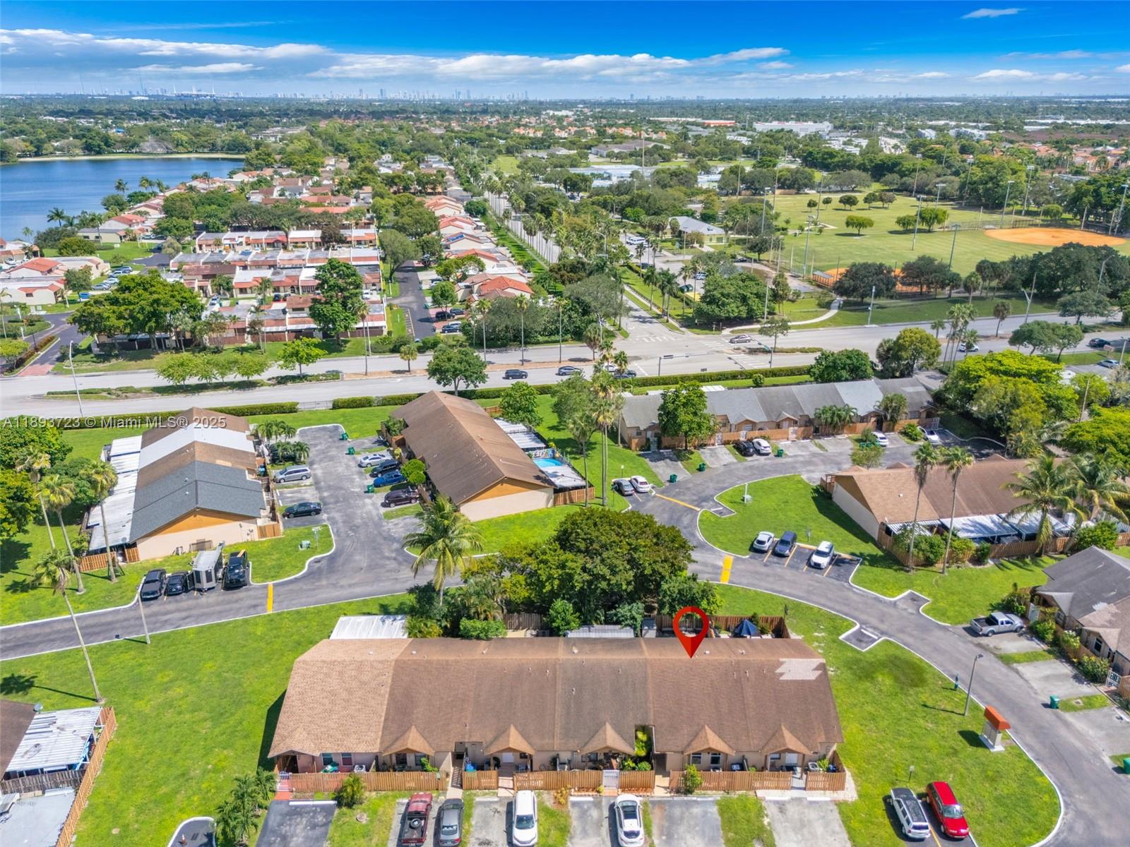 6713 Northwest 188th Terrace, Unit 6713 Hialeah, FL 33015 - Photo 23 of 28 an aerial view of a city with lots of residential buildings and mountain view in back