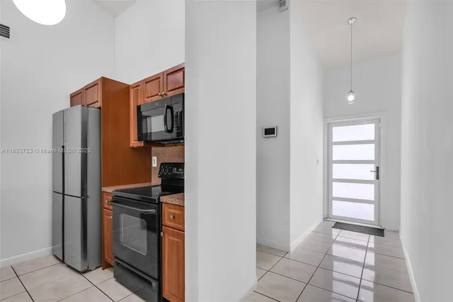 a kitchen with stainless steel appliances a refrigerator and a stove top oven