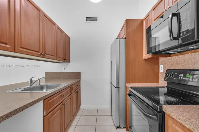 a kitchen with stainless steel appliances granite countertop a sink stove and cabinets