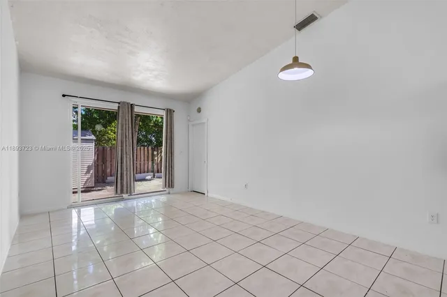 an empty room with windows and outdoor view