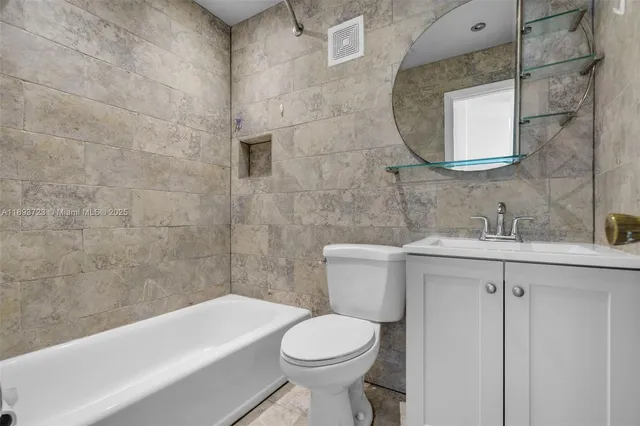 a bathroom with a sink a toilet and bathtub