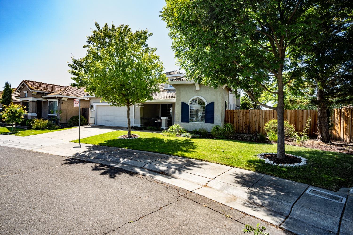 a view of a house with a yard and tree s