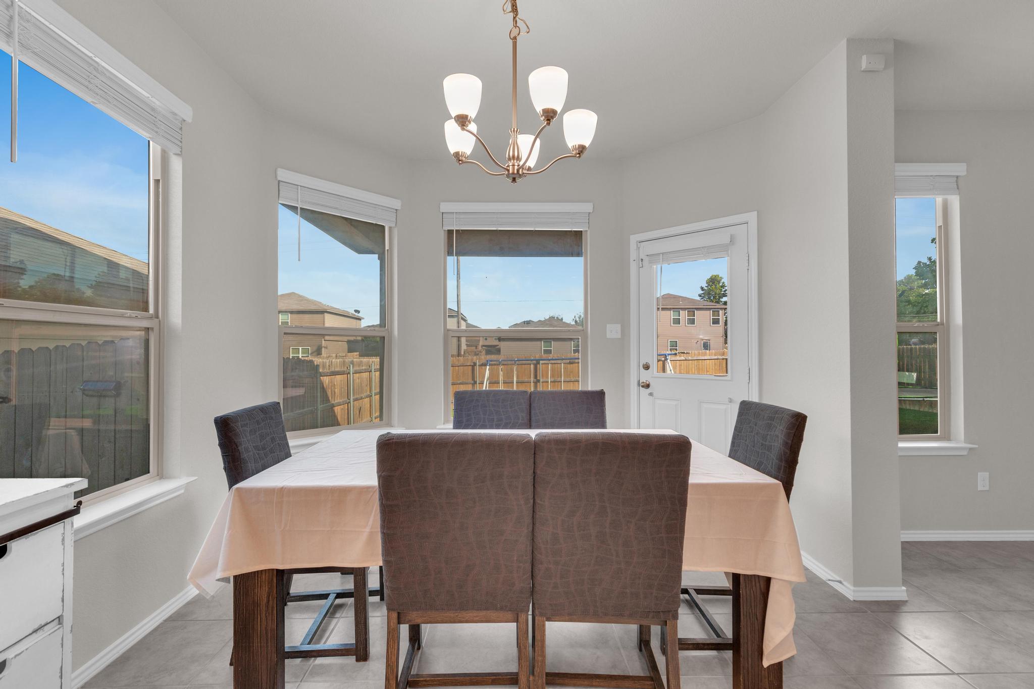 104 Uncle Billy Way Jarrell, TX 76537 - Photo 19 of 38 A well-lit dining area offers direct access to the outdoors, perfect for casual meals.