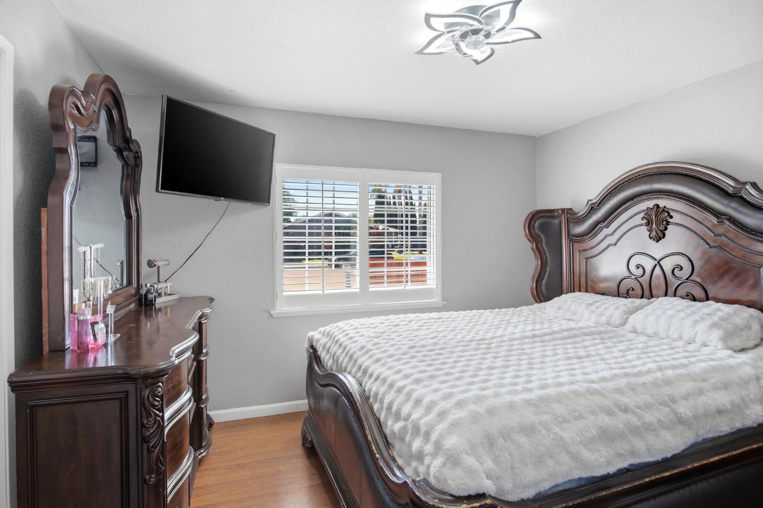 1308 Basil Court Newman, CA 95360 - Photo 14 of 20 a bedroom with a bed and dresser