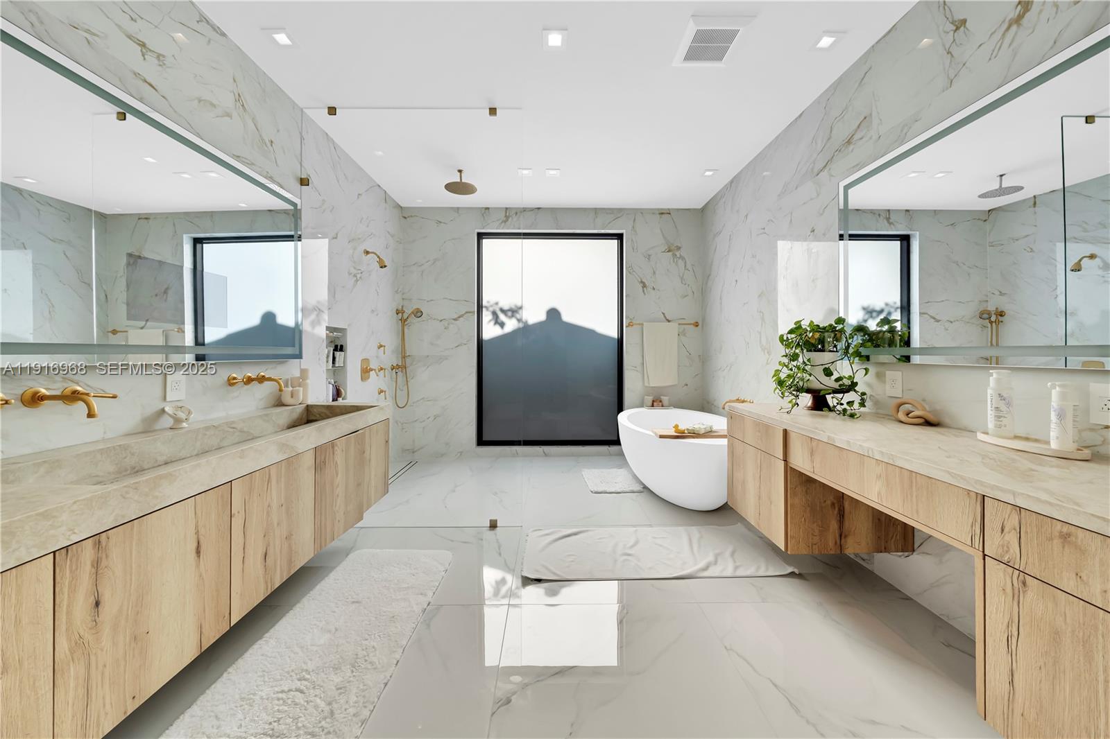 34 Southwest 26th Road Miami, FL 33129 - Photo 40 of 68 a bathroom with a double vanity sink and a bathtub