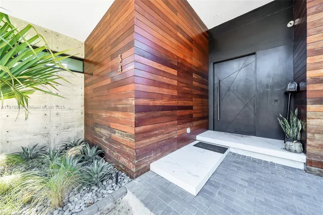 a bedroom with furniture and a large window
