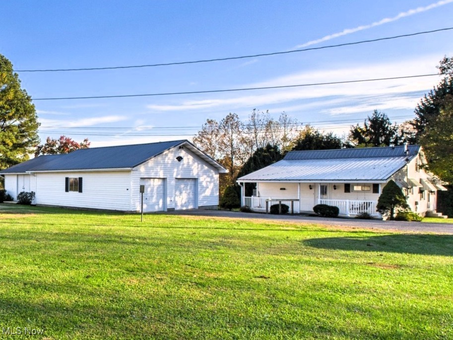 207 Stone Oak Road Davisville, WV 26142 - Photo 1 of 22 View of front of house with a front yard, an outbuilding, a porch, and a garage