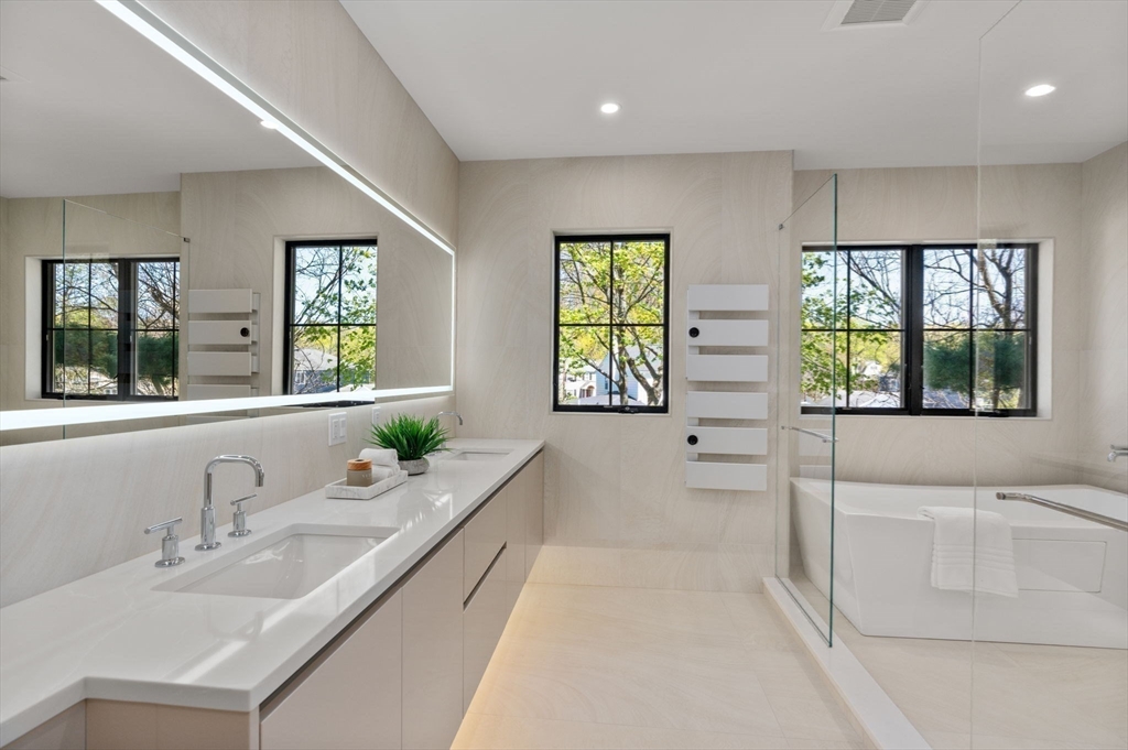 470 Quinobequin Road Newton, MA 02468 - Photo 19 of 37 a bathroom with a granite countertop sink mirror double vanity and a bathtub
