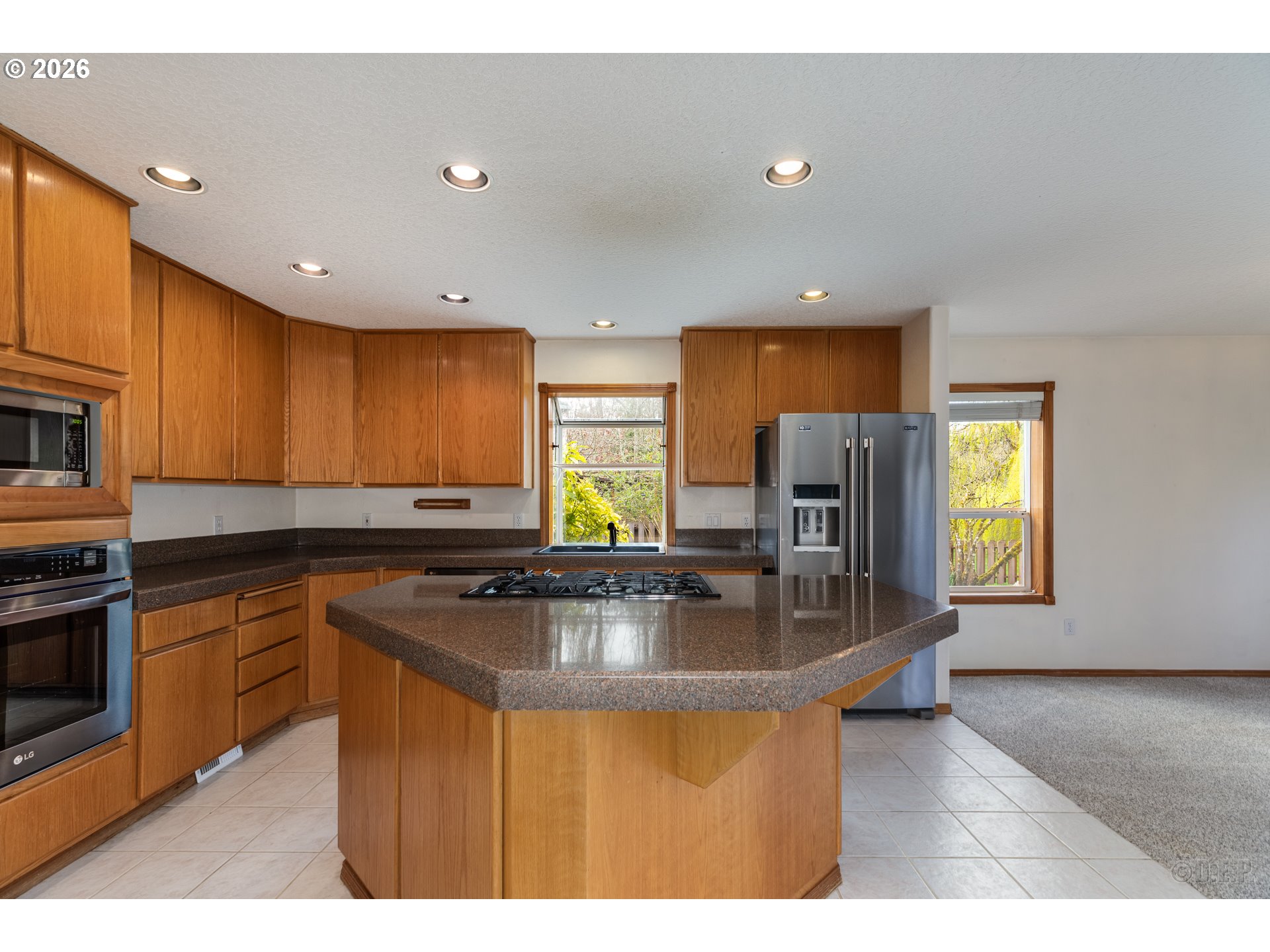 33221 Linden Street Scappoose, OR 97056 - Photo 12 of 35 a kitchen with stainless steel appliances granite countertop a sink refrigerator and microwave
