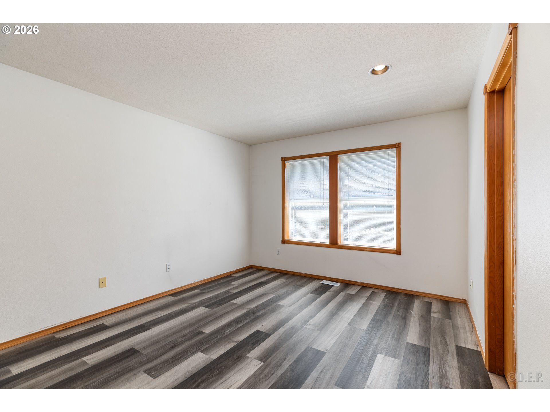 33221 Linden Street Scappoose, OR 97056 - Photo 21 of 35 a view of an empty room with wooden floor and a window