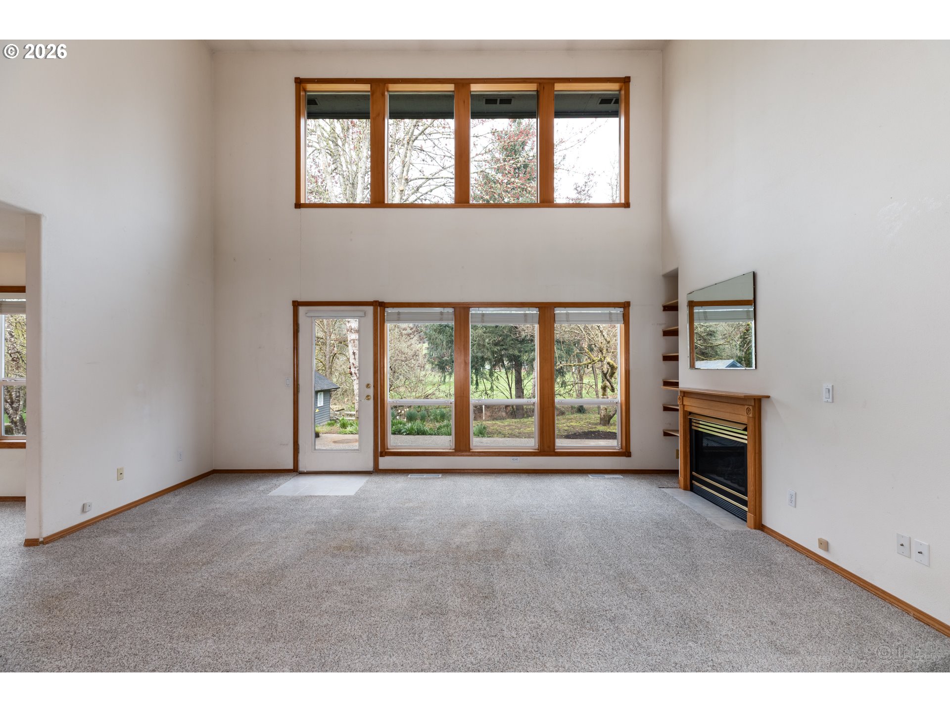 33221 Linden Street Scappoose, OR 97056 - Photo 6 of 35 a view of an empty room with a fireplace and a window