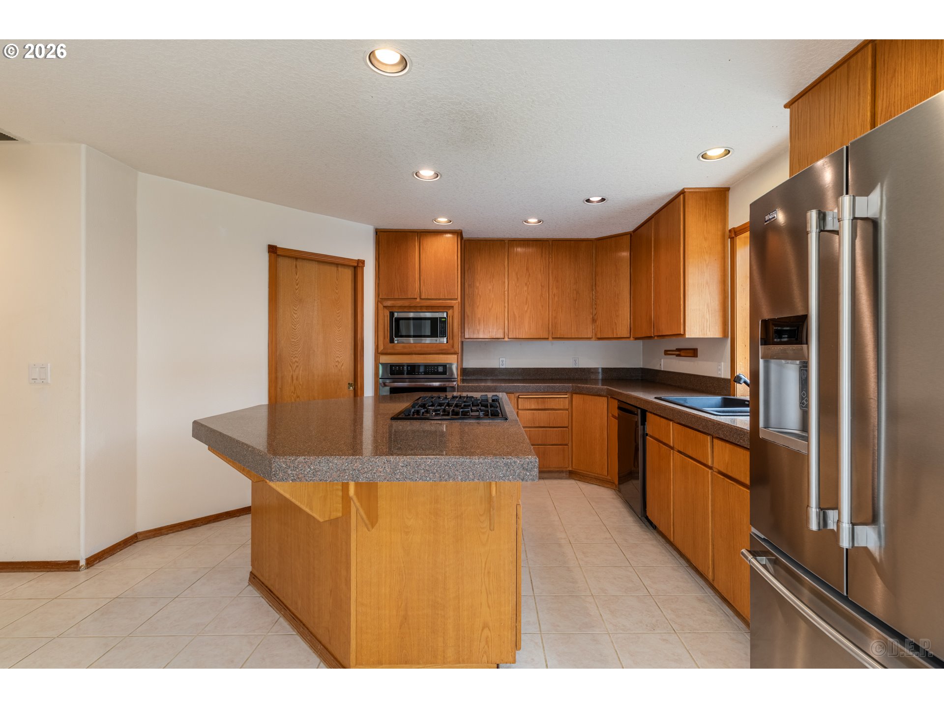 33221 Linden Street Scappoose, OR 97056 - Photo 10 of 35 a kitchen with stainless steel appliances granite countertop a sink a stove and a refrigerator