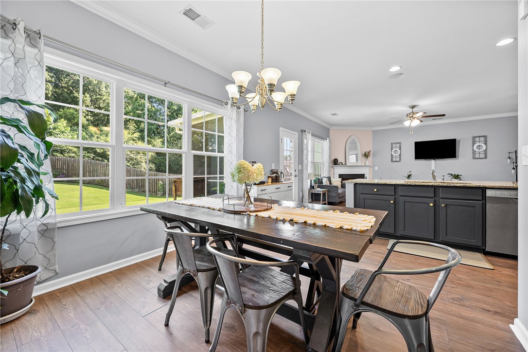 719 Camberwell Road Simpsonville, SC 29680 - Photo 11 of 47 Gleaming hardwood floors run through this airy, open-concept dining area featuring large windows.