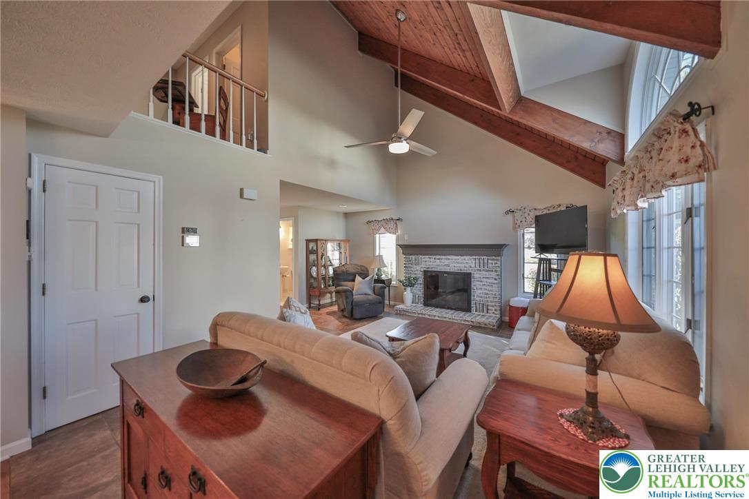 319 West Windsor Road Saylorsburg, PA 18353 - Photo 17 of 55 Light filled living room with beautiful vaulted ceilings and fireplace