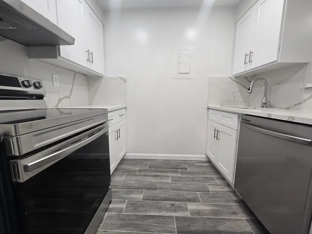 a kitchen with a stove and a sink