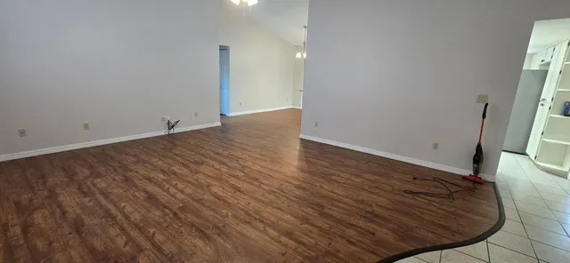 a view of a room with wooden floor and a sink