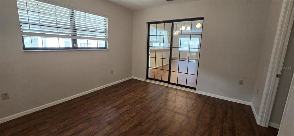 2710 Southwest 152nd Lane Ocala, FL 34473 - Photo 17 of 19 an empty room with wooden floor and windows