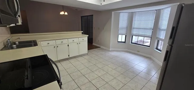 a hallway with white cabinets and window