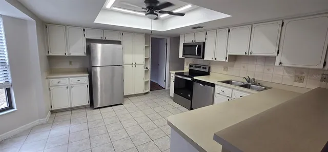 a kitchen with stainless steel appliances a refrigerator stove microwave and cabinets