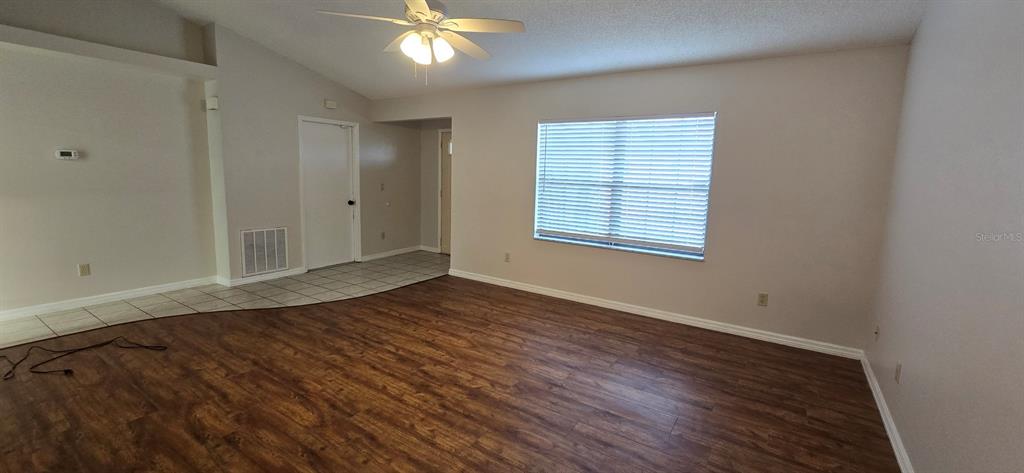 2710 Southwest 152nd Lane Ocala, FL 34473 - Photo 6 of 19 an empty room with wooden floor and windows
