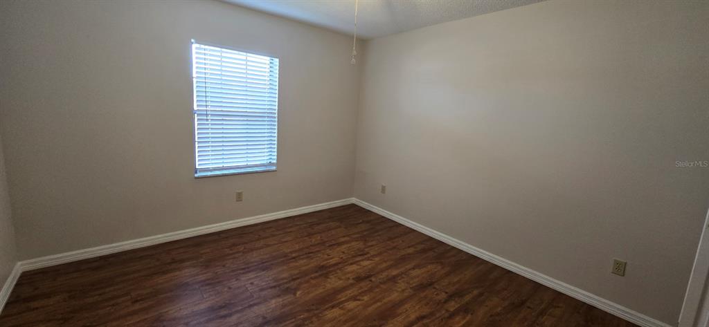2710 Southwest 152nd Lane Ocala, FL 34473 - Photo 8 of 19 a view of an empty room with wooden floor and a window