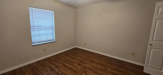 a view of a room that has wooden floor and chair
