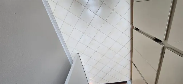 a bathroom with a white wall and shower