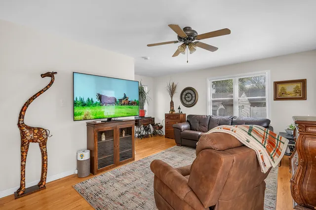 a living room with furniture a window and a flat screen tv
