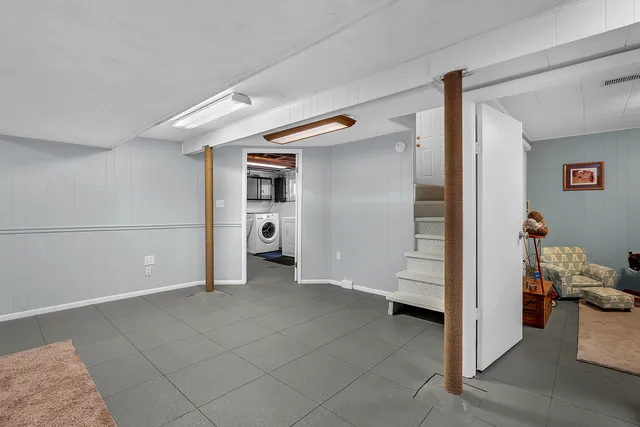 a view of a hallway with closet and cabinet