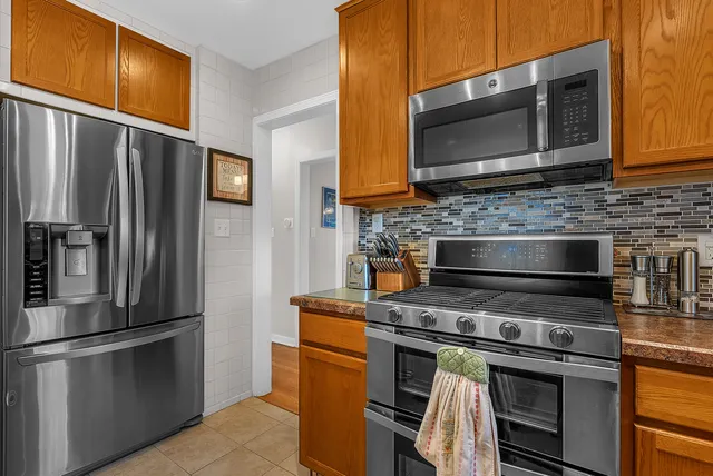 a kitchen with stainless steel appliances and cabinets