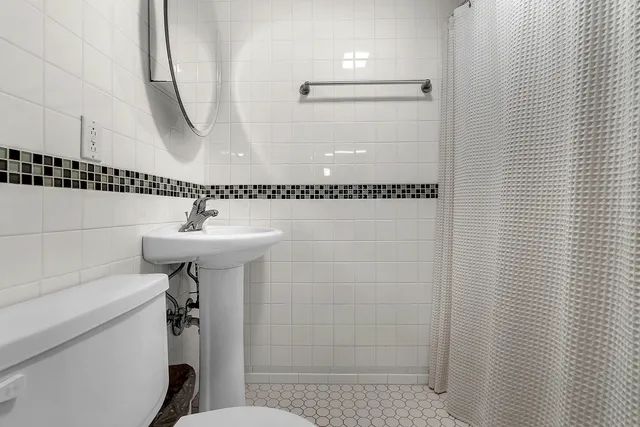 a bathroom with a shower and a sink