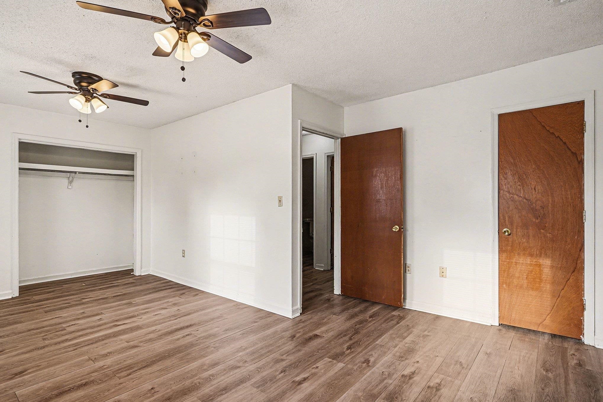 916 Brinkley Street Georgetown, SC 29440 - Photo 13 of 39 Unfurnished bedroom featuring a textured ceiling, wood finished floors, ceiling fan, and a closet