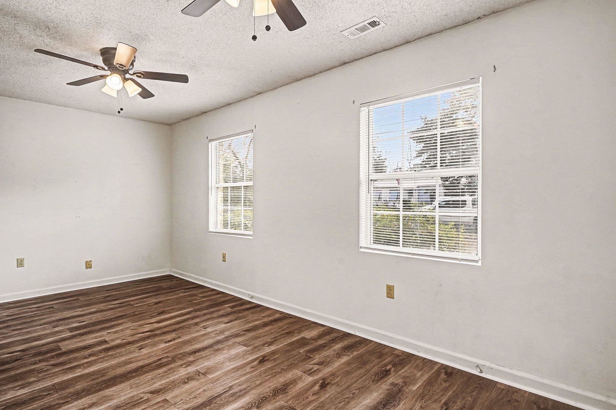 916 Brinkley Street Georgetown, SC 29440 - Photo 17 of 39 Spare room featuring dark wood finished floors, a textured ceiling, and ceiling fan