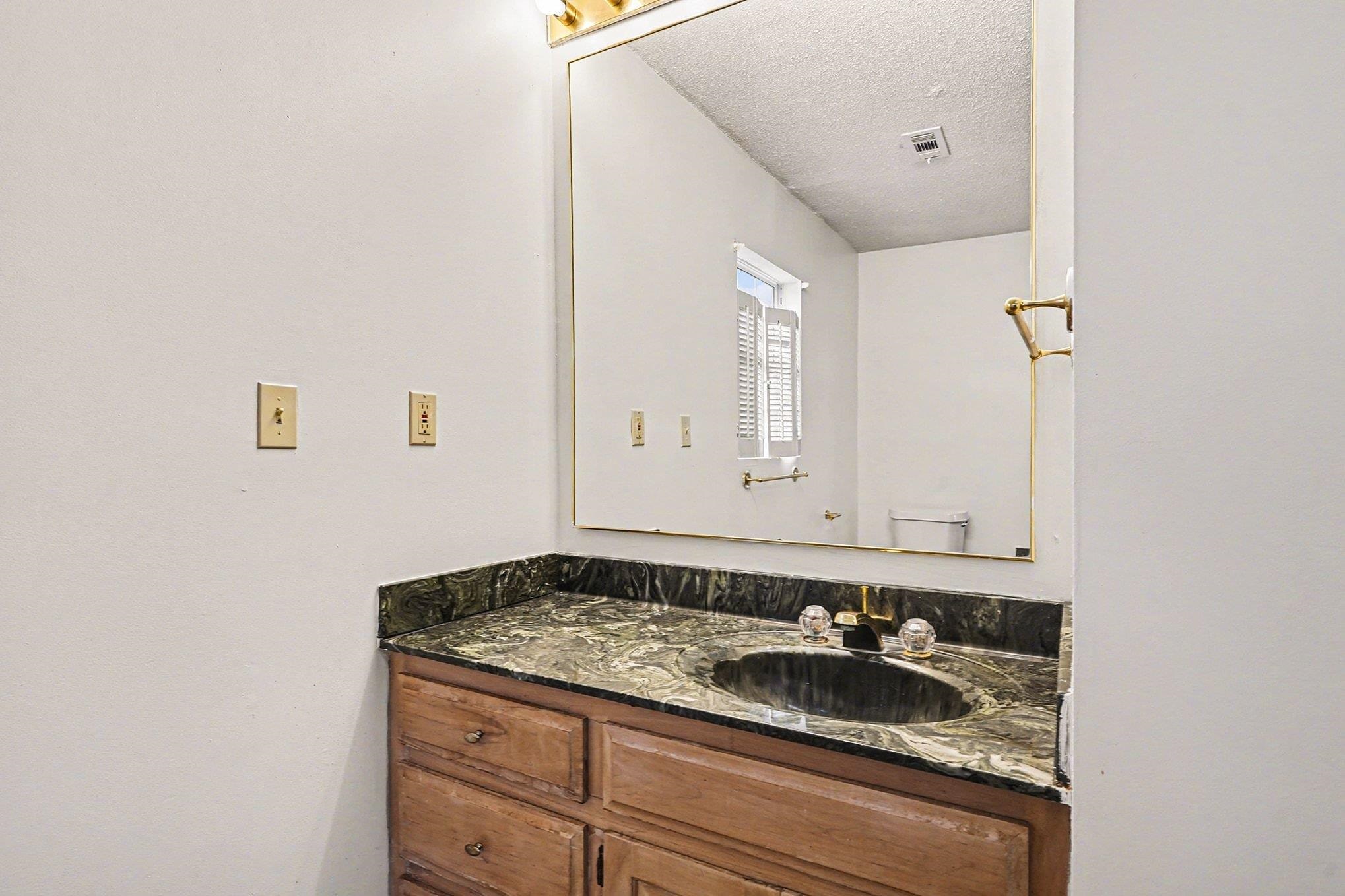 916 Brinkley Street Georgetown, SC 29440 - Photo 19 of 39 Bathroom featuring vanity and a textured ceiling