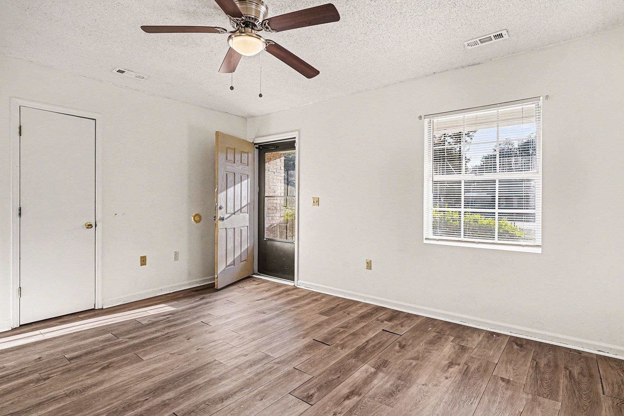 916 Brinkley Street Georgetown, SC 29440 - Photo 2 of 39 Unfurnished bedroom with a textured ceiling, light wood finished floors, and a ceiling fan